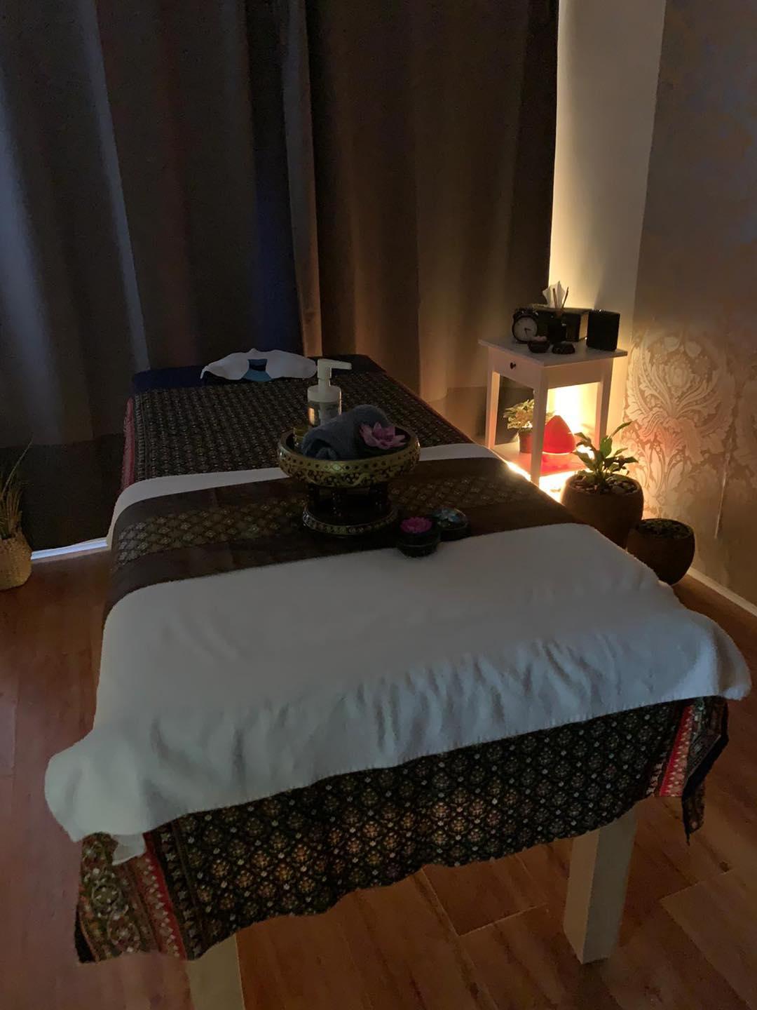 Orelia Thai Massage treatment room with traditional Thai decor, warm lighting, and relaxing ambiance